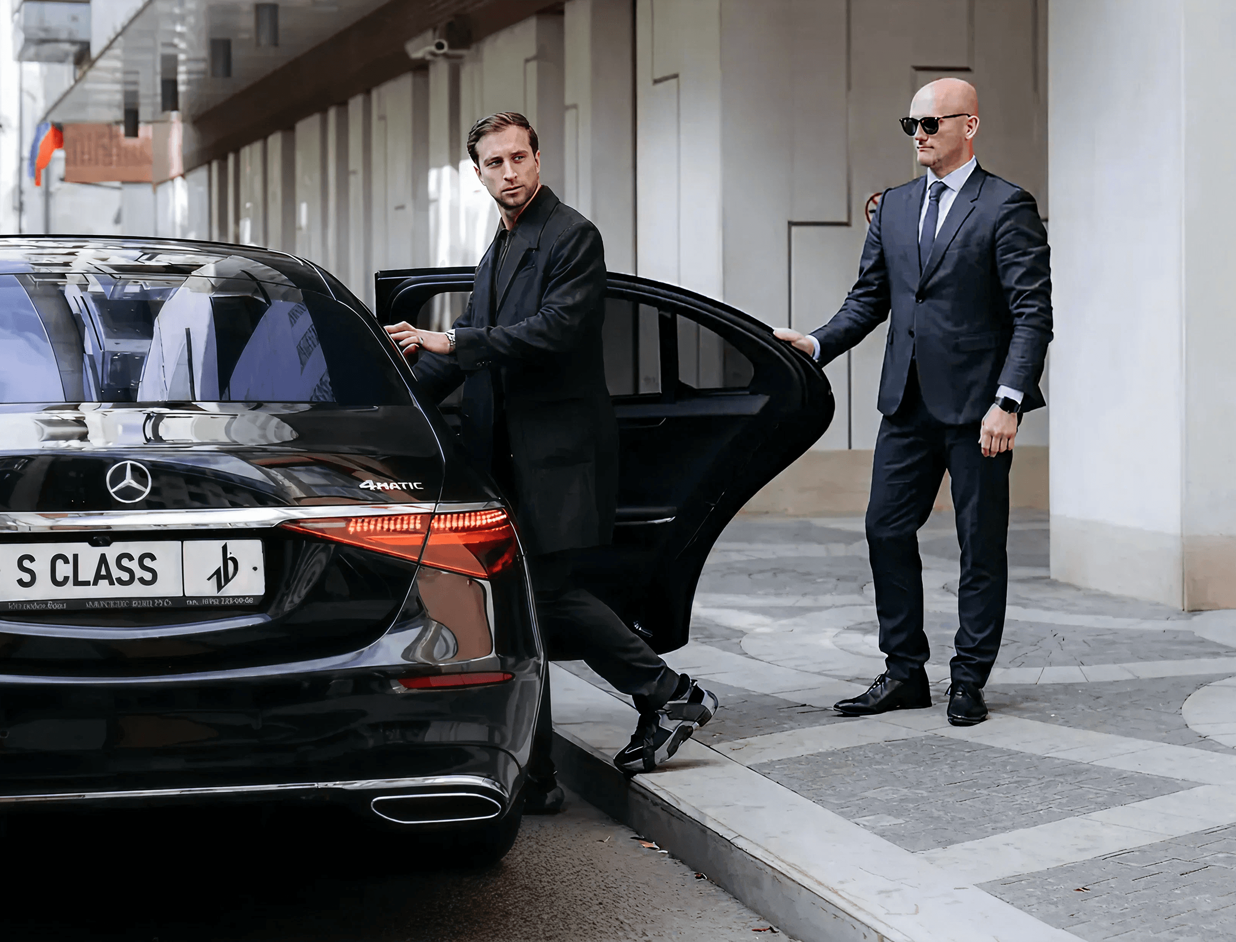 Chauffeur helping passenger at luxury vehicle in Leeds